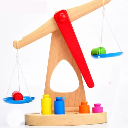 Eine Holzwaage mit bunten Kugeln darauf wird zu einer Alten Holzwaage mit bunten Kugeln darauf.